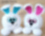 Fluffy white Easter Bunny crochet patterns with colorful ears and big eyes.