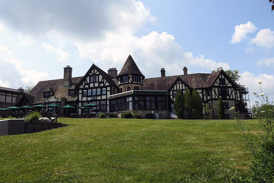 Tudor-style manor house with towers and dark trim at Punderson State Park.