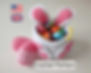 Crochet Easter Bunny basket pattern shaped like a bunny, filled with colorful eggs.