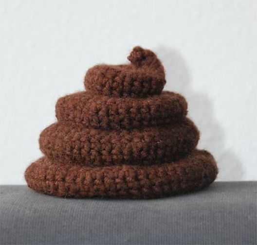 Realistic crochet poop plush on a neutral background, showcasing a detailed amigurumi crochet poop pattern with spiral texture.