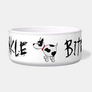 White ceramic pet bowl featuring a cartoon black and white dog with a red collar and the phrase Ankle Biter in bold black lettering.