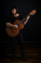 Ester Landreville holding an acoustic guitar