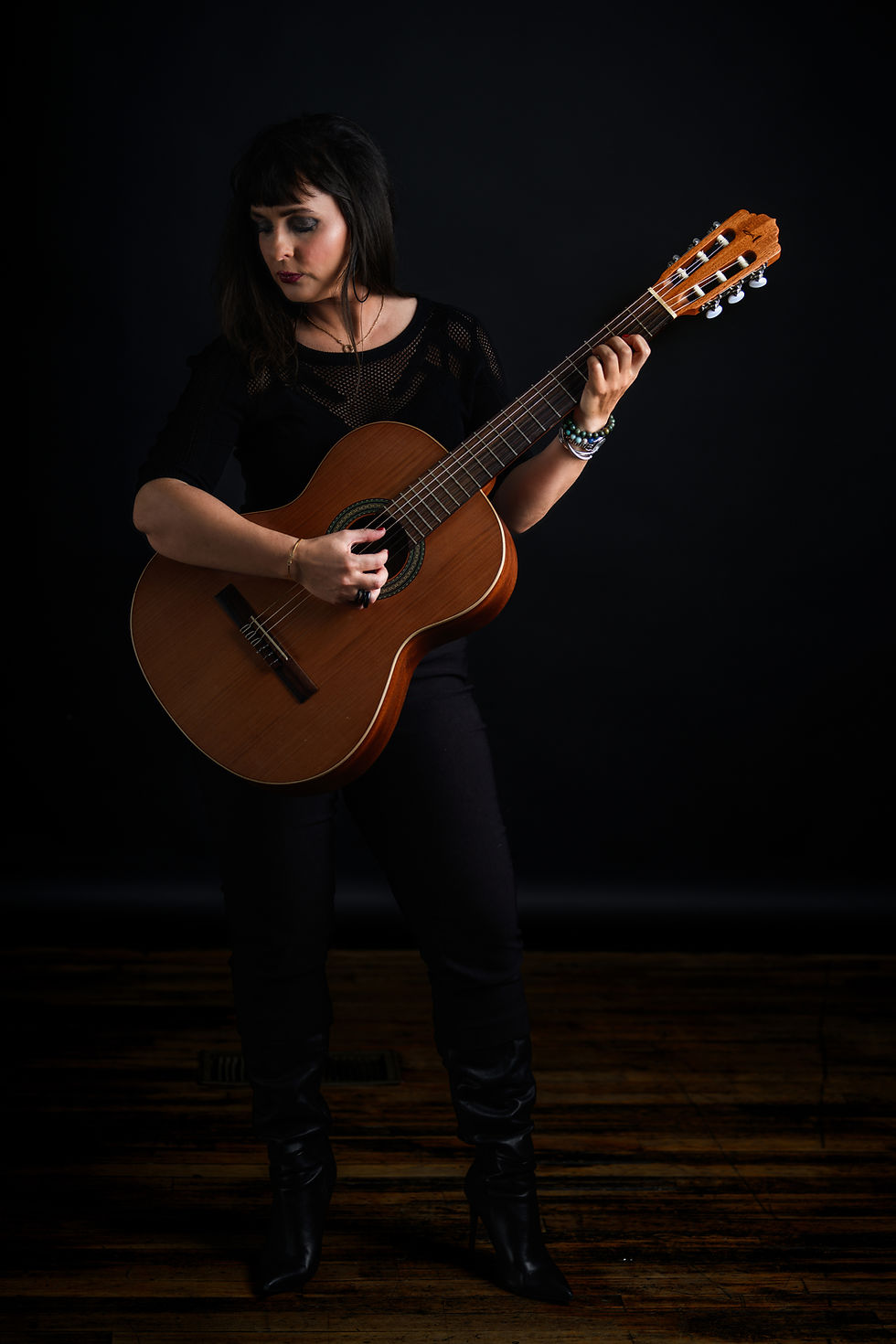 Ester Landreville holding an acoustic guitar