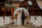 Bride and groom celebrating their wedding ceremony at a boho barn winter wedding