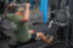 Man pulling bar over head at Vero Fitness