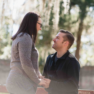 wedding photography and videography example of a man proposing to a woman under the spanish moss and oaks of Savannah, Ga.