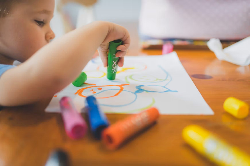 Child learning painting in afterschool program in Hoboken.