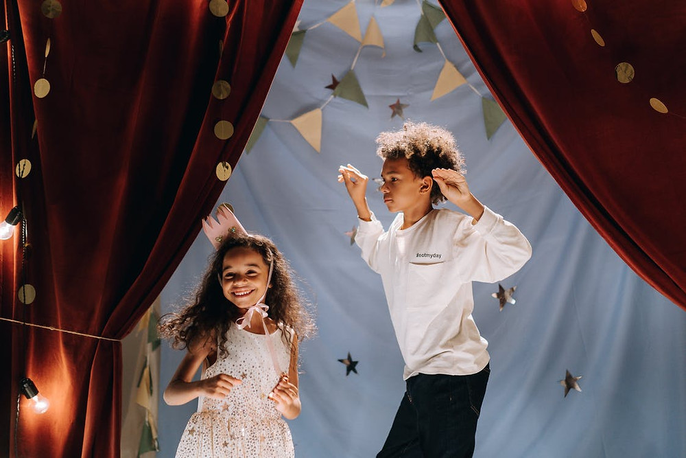 Two toddlers acting at a Children’s Acting Academy afterschool program event.