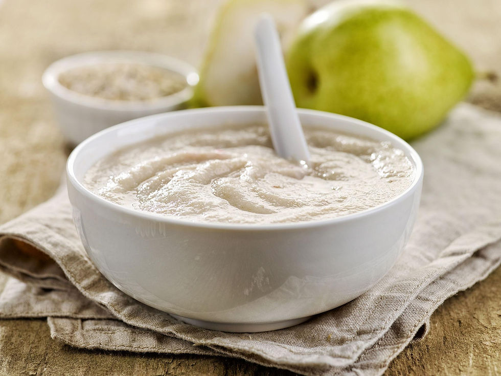 Homemade creamy oatmeal with cooked fruit prepared for baby feeding