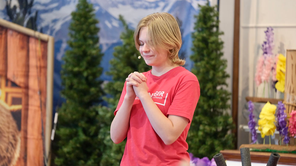 Teen leading prayer during St. Matt's VBS.