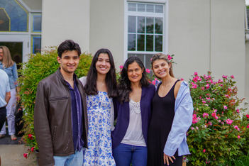 Three young adults and their mother stand together pose outside St. Matthew’s Episcopal Church in Sterling, VA on Mother’s Day