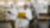 father-son-walking-through-their-food-factory-sterile-clothes-taking-notes-about-food-qual