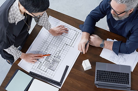 high-angle-view-two-engineers-examining-project-new-building-table-office.jpg