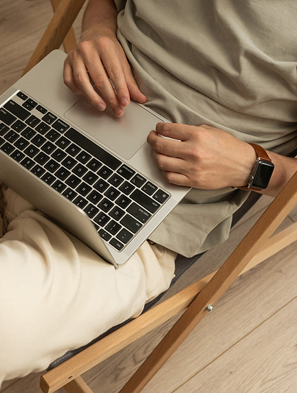 Personne assise utilisant un ordinateur portable