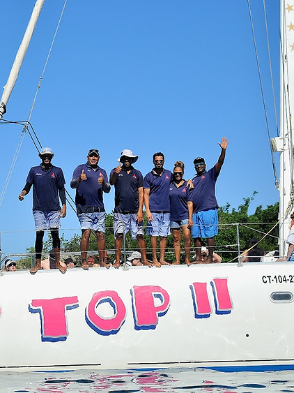 Crew standing on the Tip Top II yacht deck