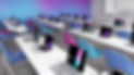 Salle de classe lumineuse avec des ordinateurs portables et chaises colorées.