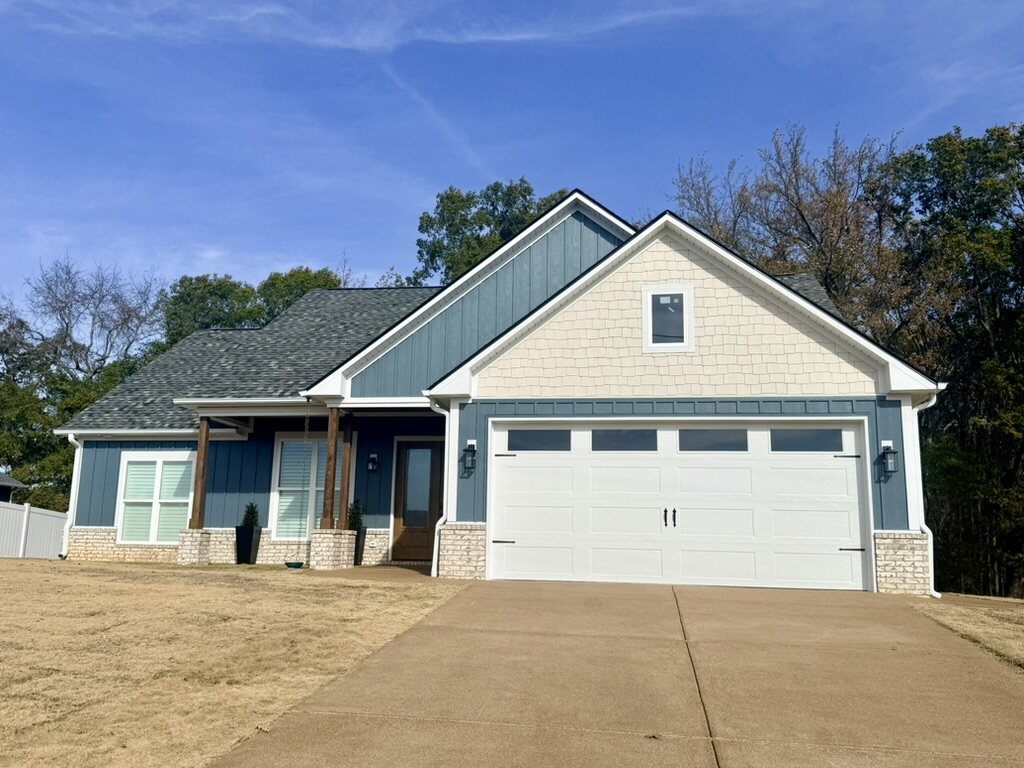 Craftsman-style home with board-and-batten siding, brick accents and a timber porch