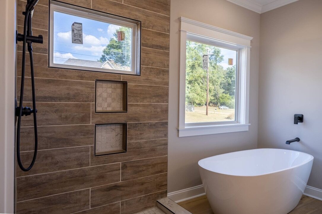 Bathroom with wood-look tile shower and a freestanding tub