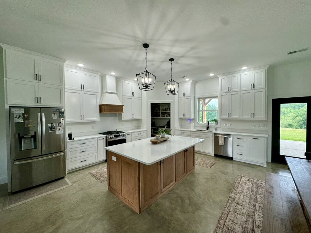Open kitchen with a stained oak island and white cabinetry