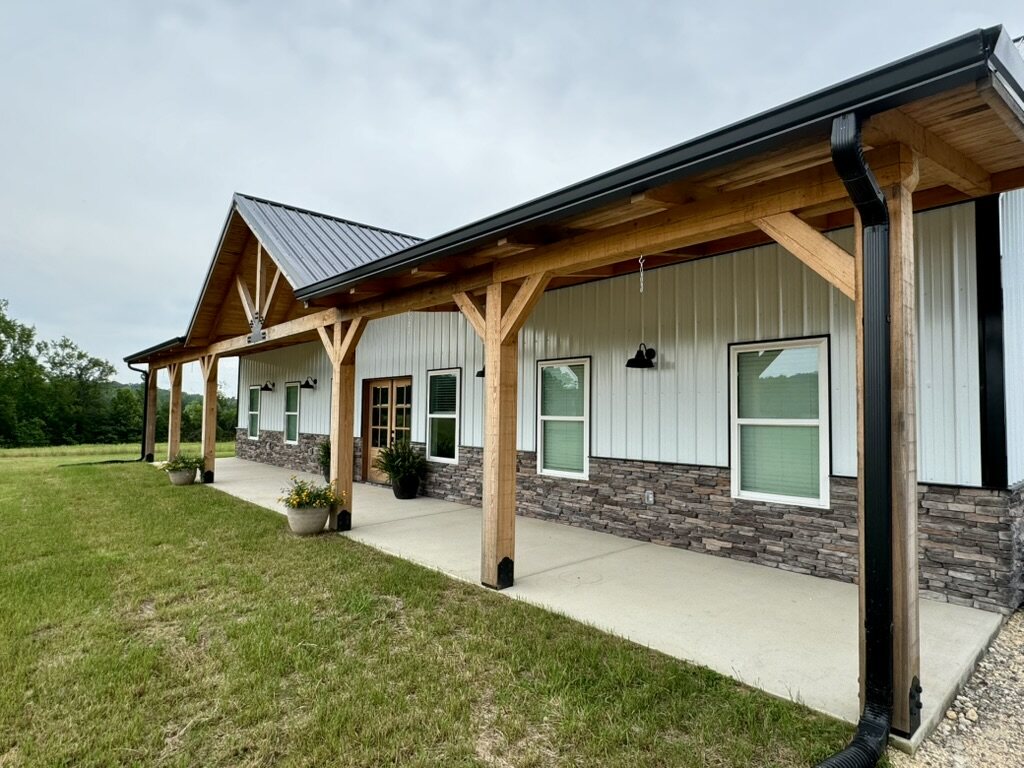 Timber-framed porch with a standing-seam metal roof