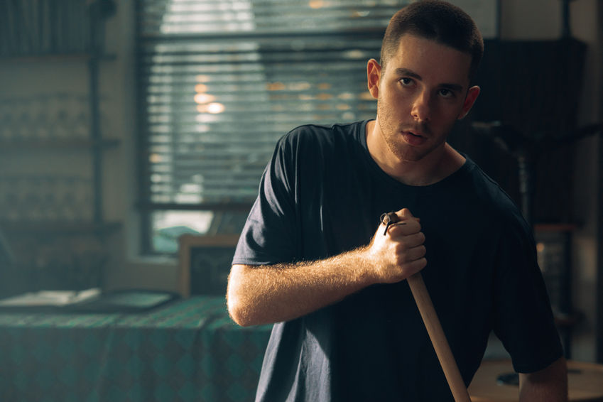 Archie holding a broom