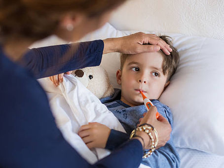 FEVER IN CHILDREN: MOTHER CHECKING FEVER BY THERMOMETER AT VELOCITY KIDS CARE