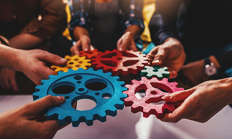 Business team work together and combine pieces of gears. Partnership and integration conce