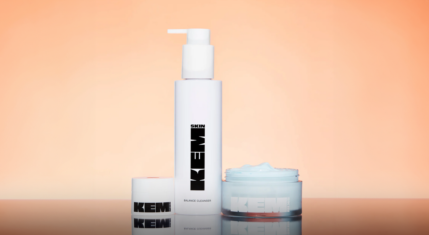 Minimalist skincare packaging design for Kem by Atin, featuring white bottles on a warm peach background.