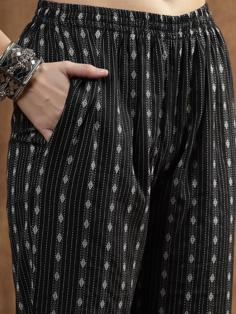 Thumbnail: Close-up of black printed straight-fit co-ord pants with comfortable side pockets