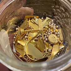 Scrap gold pieces in a jar