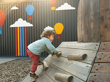 little-boy-with-long-hair-climbing-wooden-slide-public-playground-outdoors.jpg