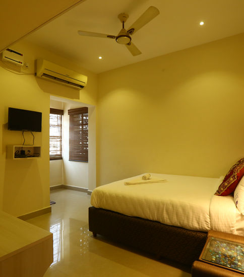 Cozy hotel room with bed, TV, window; Zingle Stay Airport, Budget Hotels Near Chennai Airport