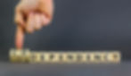 The word "codependency" written in wooden blocks with a finger pointing to "co"