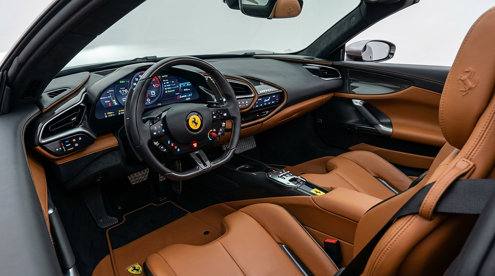 Ferrari interior with tan leather seats, digital dashboard, and steering wheel, shown in a sleek black cockpit.