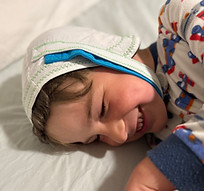 Adain in bed, smiling.jpeg
