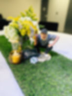 Golf figurine and yellow flowers on a grass table runner