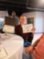 Man holding award certificates at a Past Event