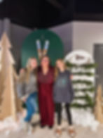 Three people posing at a winter-themed past event.