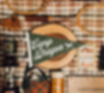 Camp Dragon pennant on a plaid backdrop with vintage gear