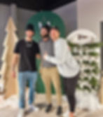 Three men smiling at a Past Events winter gathering.