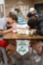 Young adults at an Arts & Crafts table during past events.