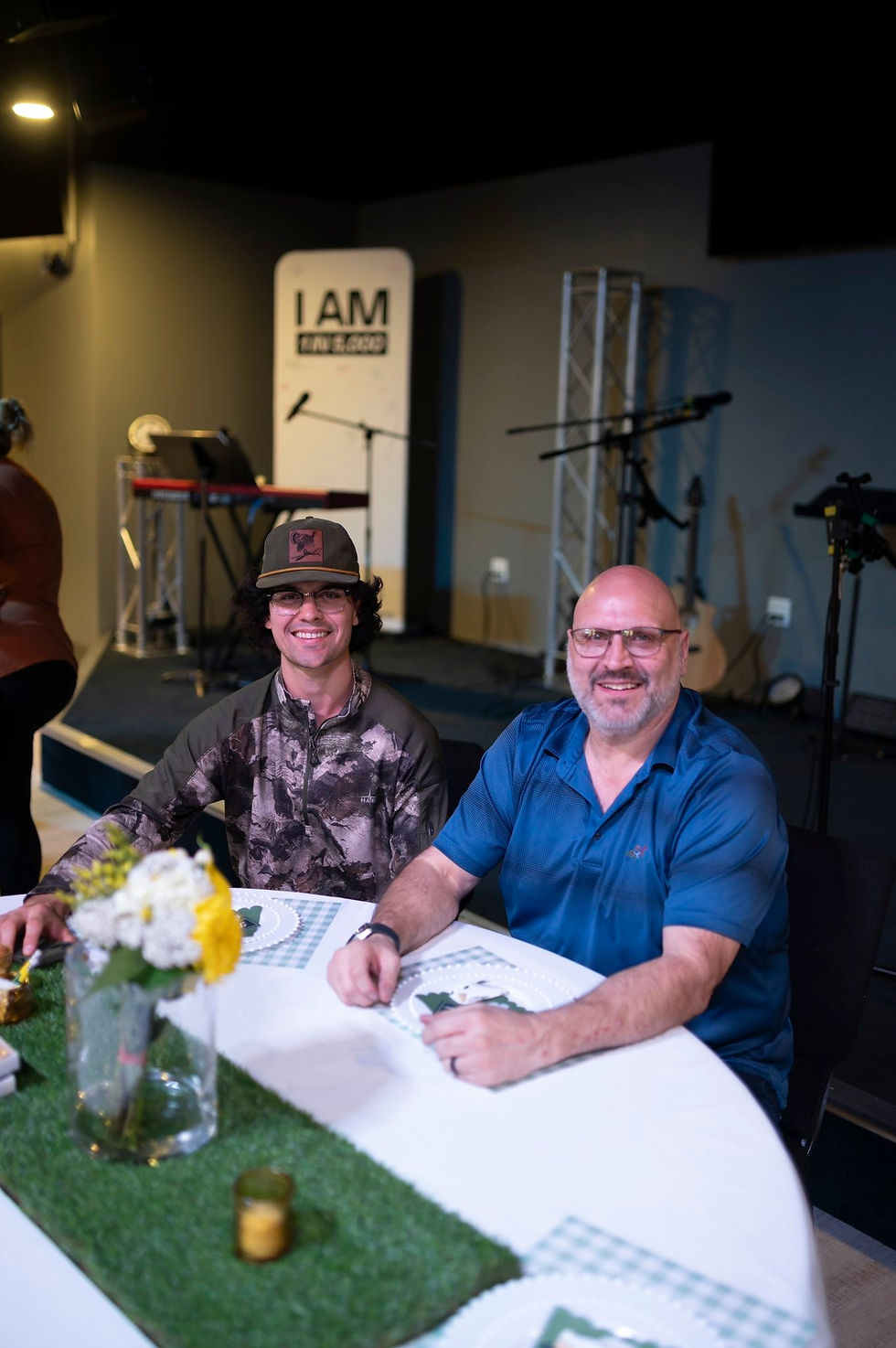 Two men smiling at a table with at a Booster Club Party