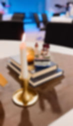 Candle and books centerpiece at a Past Events dinner.