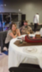 Man and woman sitting at a table during a past event.