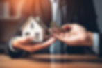 man-holding-house-with-key-his-hands.jpg