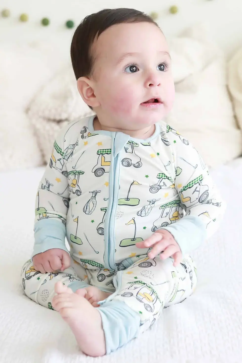 Baby wearing golf pajama romper