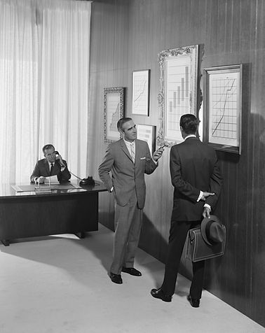 Vintage photograph of men dicussing market trends