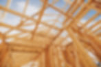 exposed lumber trusses and framing in home construction project