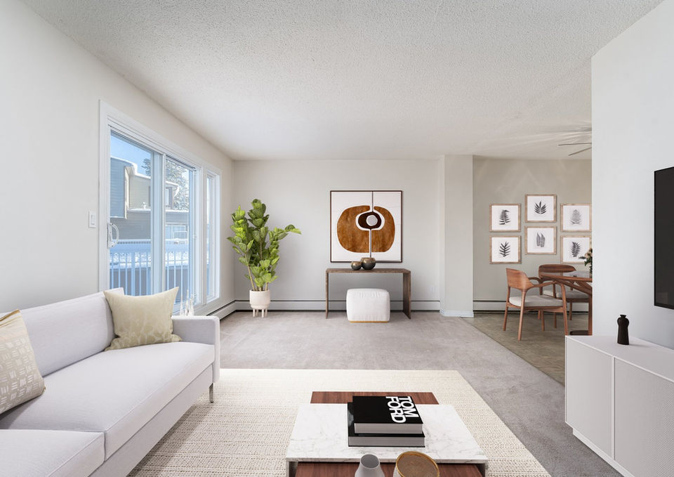 Living room with large window and modern furniture.