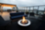 UPTEN Rooftop patio with fireplace and city views